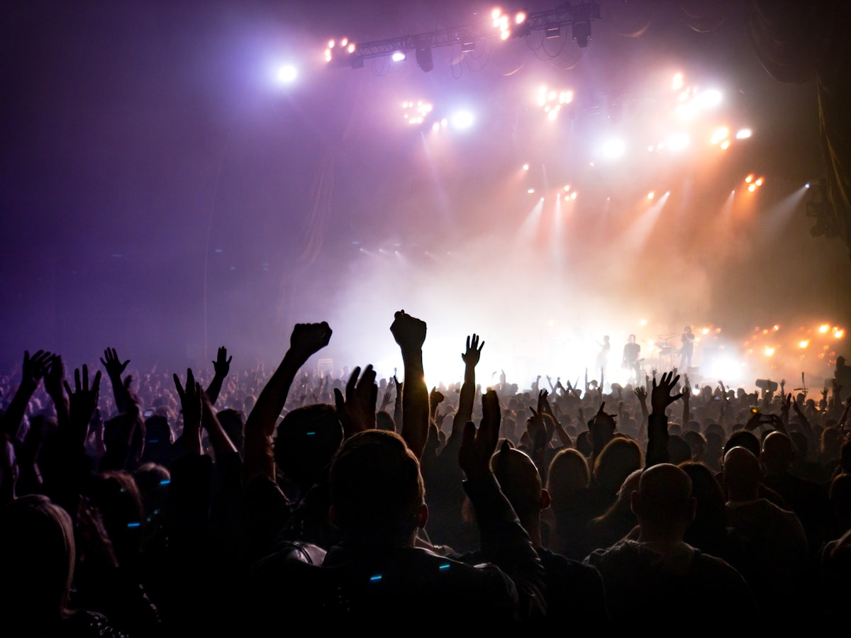 Event promoter managing a live concert with their team backstage